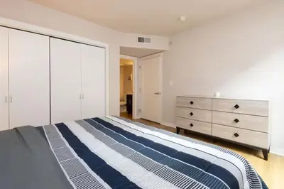 a bedroom with a large bed and a dresser at Downtown Los Angeles Gem 2 in Los Angeles