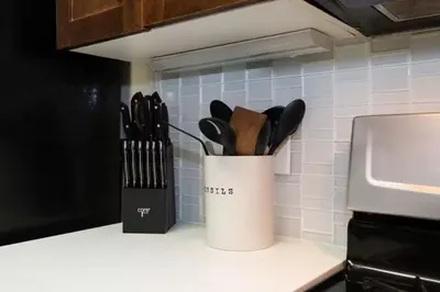 a container of kitchen utensils on a kitchen counter at Downtown Los Angeles Gem 2 in Los Angeles