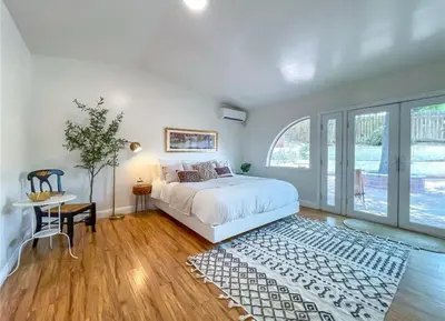a bedroom with a white bed and a large window at Hillside-This is a House with 5 master suite in Riverside