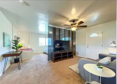 a living room with a couch and a flat screen tv at Hillside-This is a House with 5 master suite in Riverside