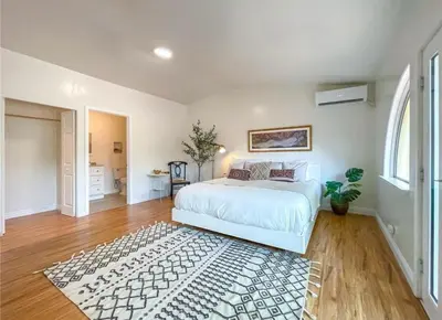 a bedroom with a white bed and a rug at Hillside-This is a House with 5 master suite in Riverside