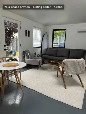 a living room with a black couch and a table at Venice Beach Boho - 2 apartments in Los Angeles