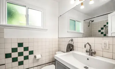 a bathroom with a sink and a toilet and a mirror at Venice Beach Boho - 2 apartments in Los Angeles
