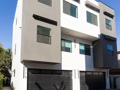 a facade of a white building with windows at Modern Luxe Retreat 3-Bedroom #3 in Los Angeles