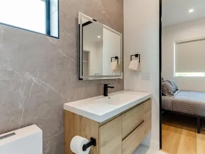 a bathroom with a sink and a mirror at Modern Luxe Retreat 3-Bedroom #3 in Los Angeles