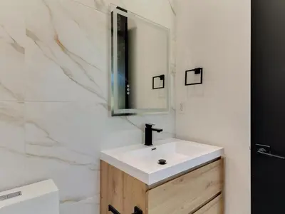 a bathroom with a white sink and a mirror at Modern Luxe Retreat 3-Bedroom #3 in Los Angeles