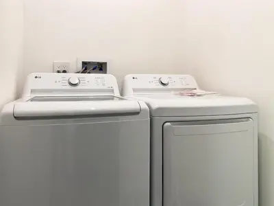two white washing machines in a white room at Modern Luxe Retreat 3-Bedroom #3 in Los Angeles