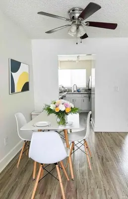 a dining room with a table and chairs and a ceiling fan at Spacious 2BR Townhouse - 3 Queens - Sleeps 8 in Redondo Beach