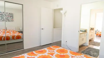 a bedroom with white walls and a large mirror at Spacious 2BR Townhouse - 3 Queens - Sleeps 8 in Redondo Beach