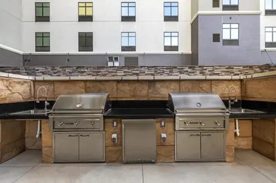 a kitchen with two sinks in front of a building at Home2 Suites By Hilton Riverside Downtown in Riverside