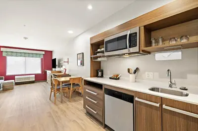a kitchen with a sink and a counter top at Home2 Suites By Hilton Riverside Downtown in Riverside
