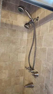 a shower with a shower head in a bathroom at Cheerful Single Story 3-bedroom home w pool table in Santa Clarita
