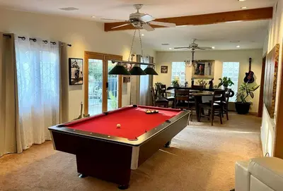 a room with a pool table and a dining room at Cheerful Single Story 3-bedroom home w pool table in Santa Clarita