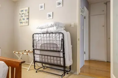 a towel rack in a room with a pile of towels at Steps to Ocean Bliss in Long Beach