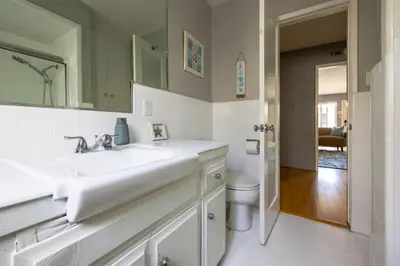 a white bathroom with a sink and a toilet at Steps to Ocean Bliss in Long Beach