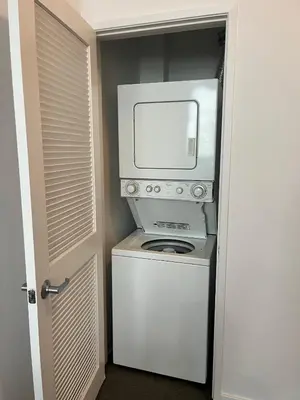 a microwave and a washer and dryer in a room at The NoHo Artist Nook in Burbank