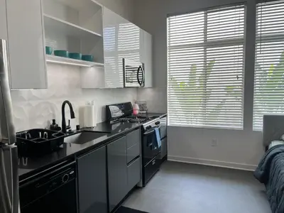 a kitchen with a sink and a stove at The NoHo Artist Nook in Burbank