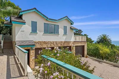 a house with a blue bench in front of it at Blue Ocean View Retreat - Minutes to Beach in Summerland