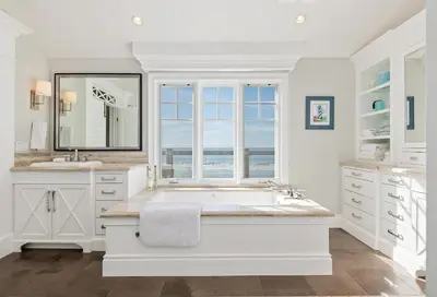 a white bathroom with a tub and a window at Seacliff Beach Retreat - Amazing Beachfront for Family of 6 in Ventura