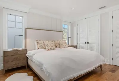 a white bedroom with a large bed and a dresser at Seacliff Beach Retreat - Amazing Beachfront for Family of 6 in Ventura