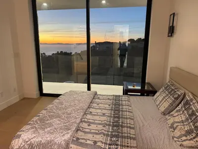 a bedroom with a bed and a large window at Ocean Vista in Palos Verdes Estates