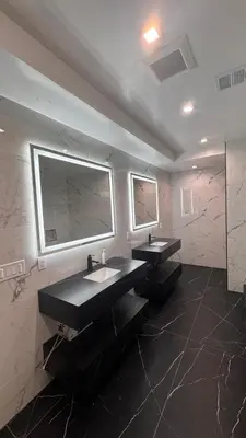 a bathroom with two sinks and a large mirror at Ocean Vista in Palos Verdes Estates