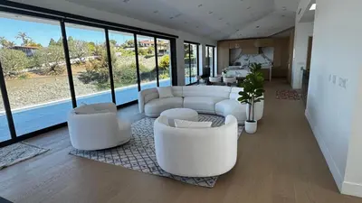 a living room with white furniture and large windows at Ocean Vista in Palos Verdes Estates