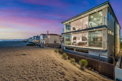 a house on the beach with the ocean at Modern Ocean Front Beach Home- 3 king beds 3 bedroom in Oxnard