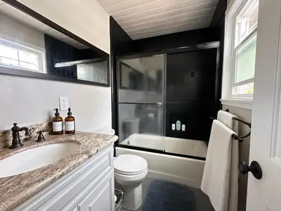 a bathroom with a sink and a toilet and a shower at Perch - Peaceful ECO Cedar Hot Tub AC EV Mountain Views in Running Springs
