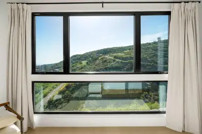 a window with a view of a mountain at Samara by Stay Awhile Villas in Malibu