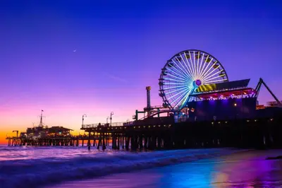 a ferris wheel on the beach next to a pier at Claudia's Guest House in Los Angeles