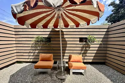 a table and two chairs under an umbrella at Claudia's Guest House in Los Angeles