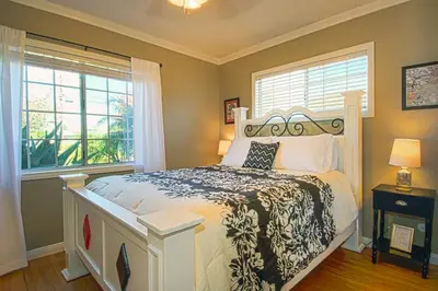 a bedroom with a bed and two windows at F-13 California Dreamin in Anaheim