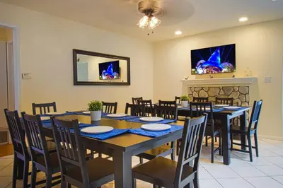 a dining room with a table and chairs and a fireplace at F-13 California Dreamin in Anaheim