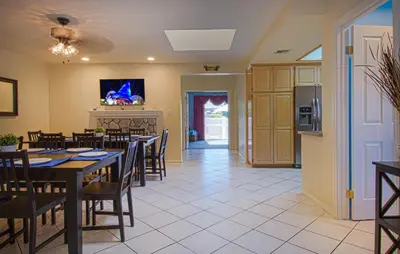 a dining room with tables and chairs and a kitchen at F-13 California Dreamin in Anaheim