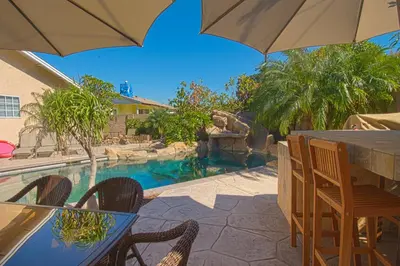 a patio with a table and chairs and a swimming pool at F-13 California Dreamin in Anaheim