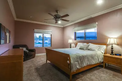 a bedroom with a bed and a ceiling fan at F-25 Belles Castle in Anaheim