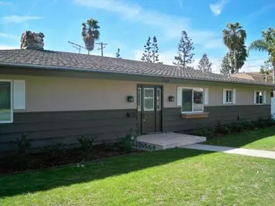 a house with a door and a grass yard at F-28 The Wonderland House in Anaheim