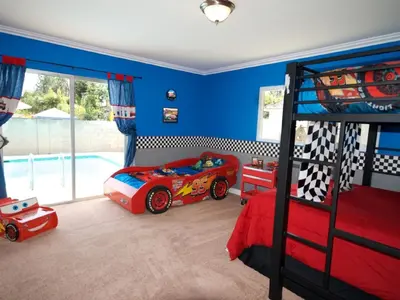 a childs bedroom with a red race car bed at F-28 The Wonderland House in Anaheim