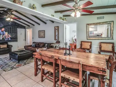 a living room with a wooden table and a couch at F-29 The Pirates Cove in Anaheim