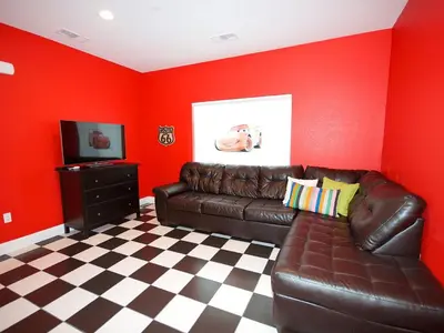 a living room with a leather couch and a television at F-31 Mickeys Beach House in Anaheim