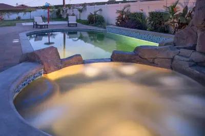 a swimming pool with a table and chairs next to it at F-32 La Casa de Mickey in Anaheim