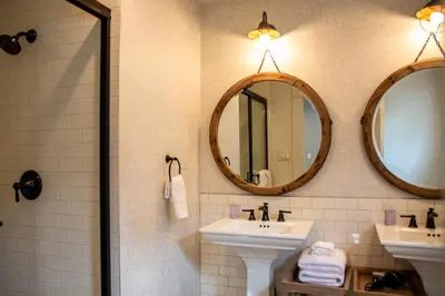 a bathroom with two sinks and two mirrors at F-39 Helena in Anaheim