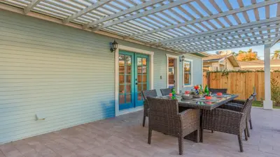 a patio with a table and chairs and a pergola at F-39 Helena in Anaheim