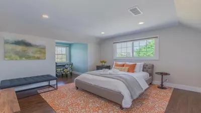a bedroom with a bed and a couch and windows at F-51 Orangewood in Anaheim
