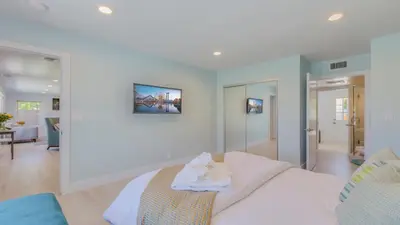 a bedroom with a bed and a living room at F-51 Orangewood in Anaheim