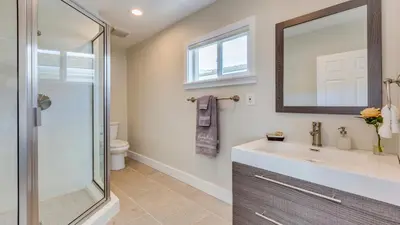 a bathroom with a sink and a glass shower at F-52 Trenton II in Anaheim