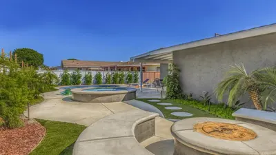 a backyard with a swimming pool and a building at F-53 Trenton in Anaheim