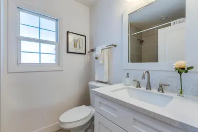 a white bathroom with a toilet and a sink at F-53 Trenton in Anaheim