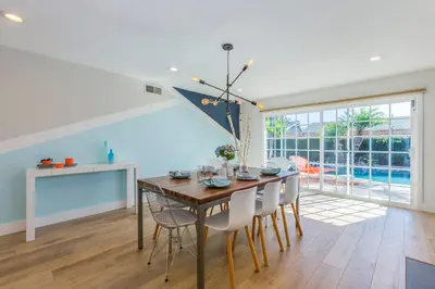 a dining room with a wooden table and chairs at F-54 Maverick in Anaheim